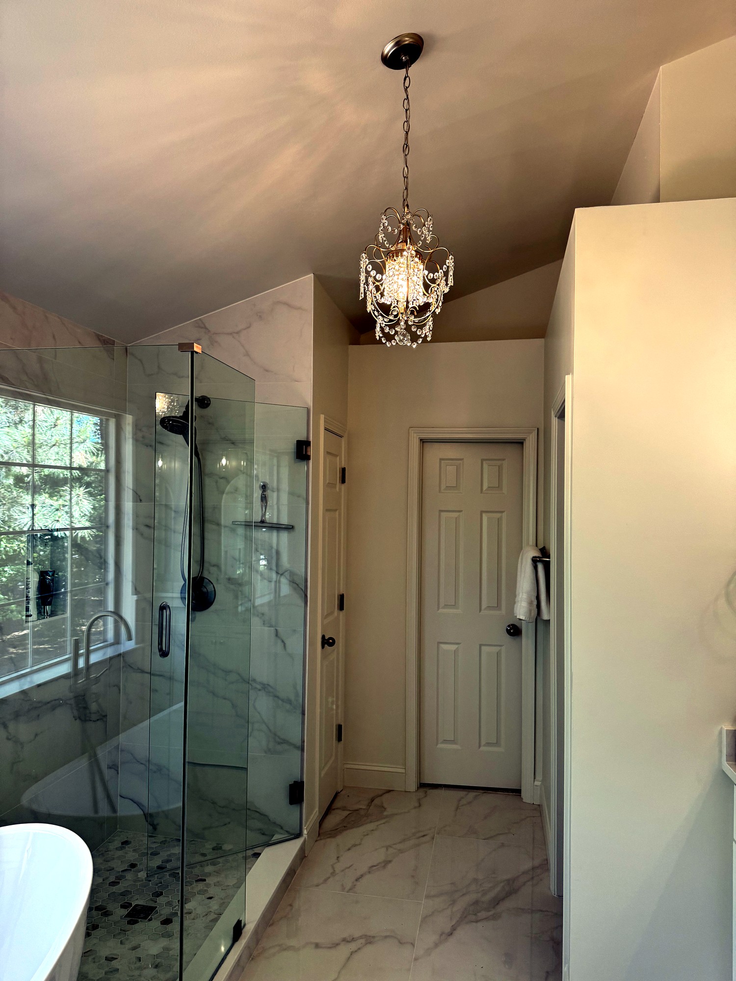 Hexagon tile walk-in shower floor with glass enclosure