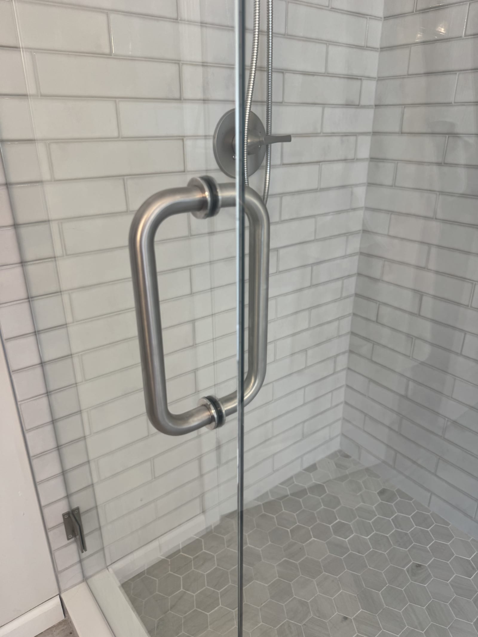 Frameless glass shower door hardware detail